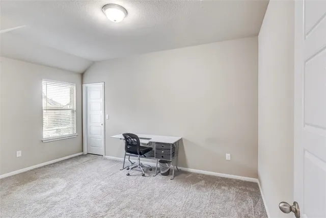 an empty room with windows and lounge chair