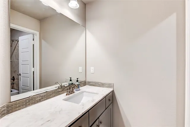 a bathroom with a sink and a mirror