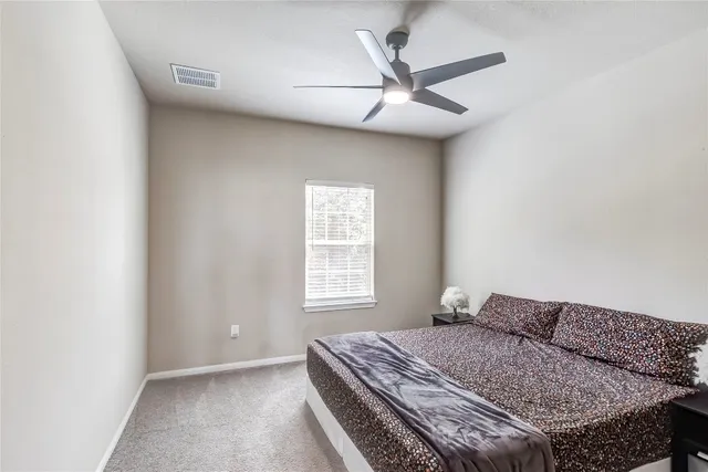 a bed sitting in a bedroom next to a window