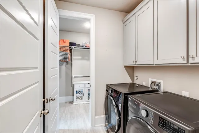 a utility room with closet dryer and washer