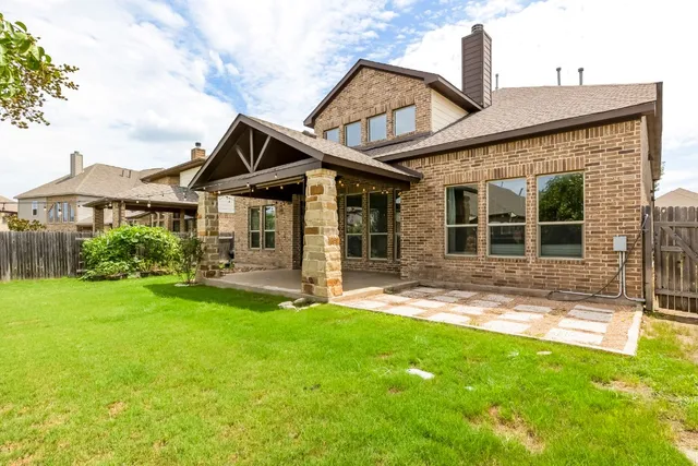 a front view of a house with a yard and porch