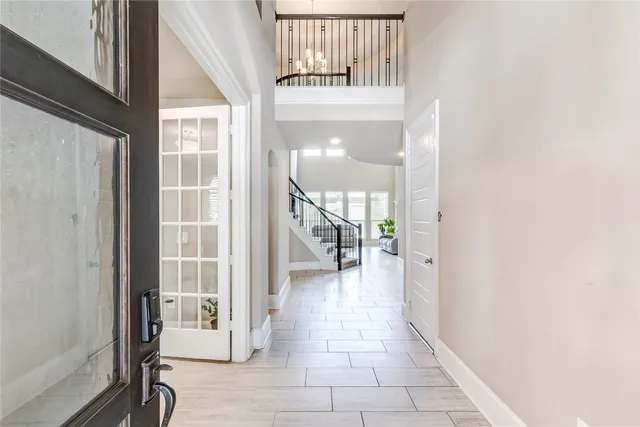 a view of a hallway with wooden floor and entryway