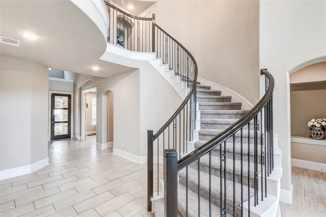 a view of staircase with white walls and next to a window