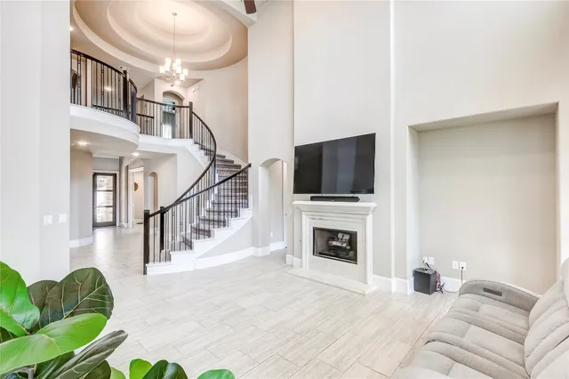 a living room with furniture fireplace and flat screen tv