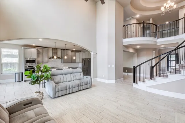 a living room with furniture and a chandelier