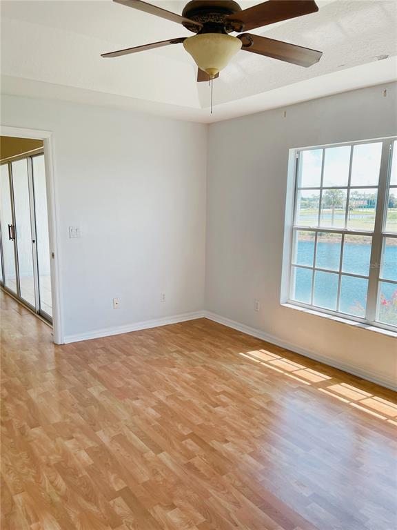 427 Eagle Ridge Drive Davenport, FL 33837 - Photo 13 of 39 a view of an empty room with a window and wooden floor