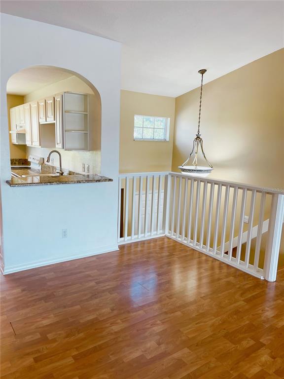 427 Eagle Ridge Drive Davenport, FL 33837 - Photo 21 of 39 a view of an empty room with wooden floor and a window