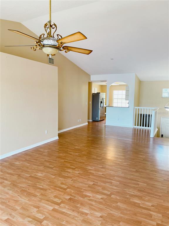 427 Eagle Ridge Drive Davenport, FL 33837 - Photo 27 of 39 a view of a room with wooden floor window and a kitchen