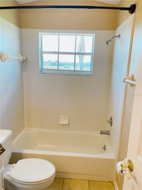 427 Eagle Ridge Drive Davenport, FL 33837 - Photo 32 of 39 a bathroom with a toilet and a bath tub