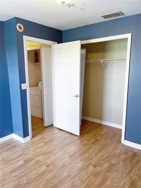 427 Eagle Ridge Drive Davenport, FL 33837 - Photo 37 of 39 a view of an empty room with wooden floor and a window