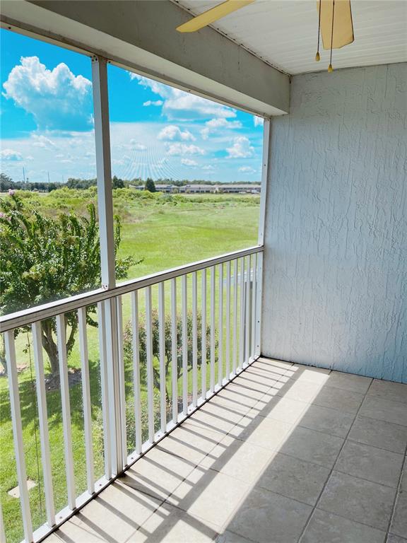 427 Eagle Ridge Drive Davenport, FL 33837 - Photo 4 of 39 a view of a room with wooden floor and chair