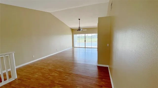 a view of an empty room with wooden floor
