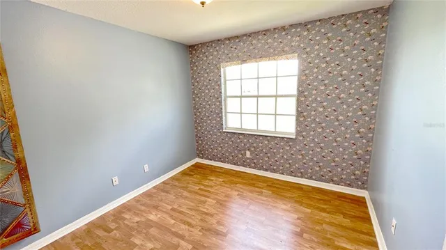 a bathroom with a granite countertop toilet a sink and a mirror