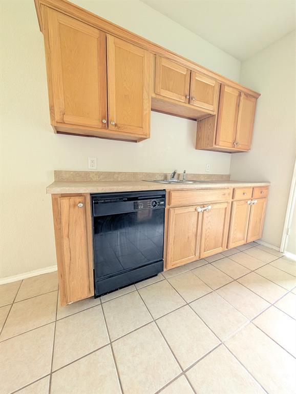 120 Collett Court Weatherford, TX 76088 - Photo 3 of 10 a kitchen with granite countertop a stove a sink and a microwave