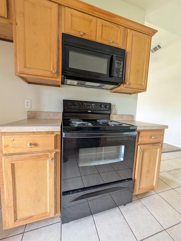 120 Collett Court Weatherford, TX 76088 - Photo 4 of 10 a kitchen with granite countertop cabinets stainless steel appliances and wooden floor