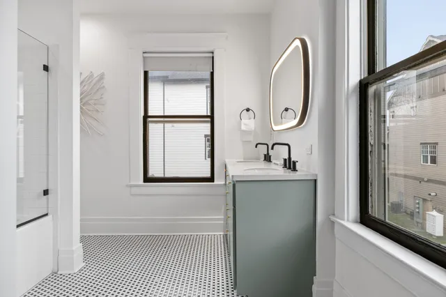 a bathroom with a sink a mirror and a shower