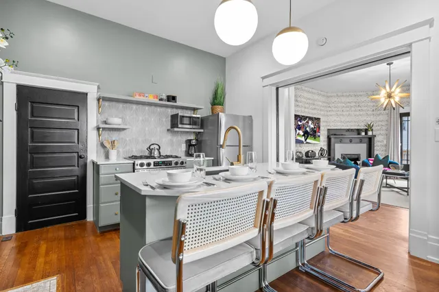 a kitchen with a sink cabinets and wooden floor