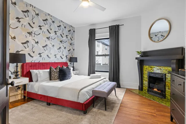 a bedroom with bed and a fireplace