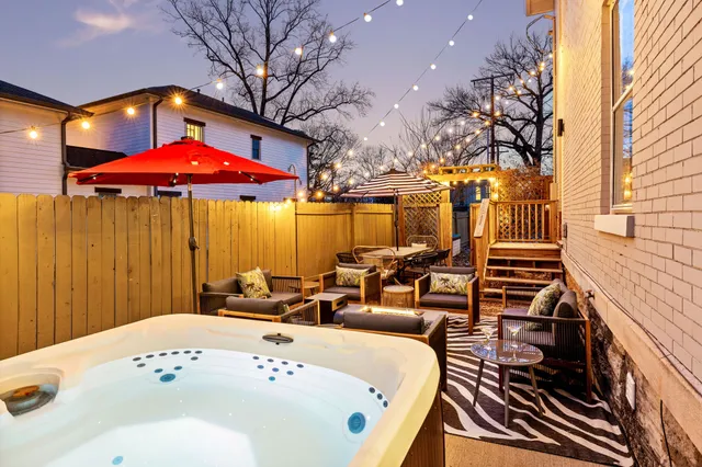 a view of a chairs and table on the deck in front of house