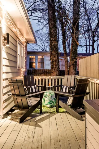 a view of a room that has a couch and chandelier