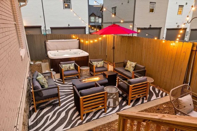 an outdoor sitting area with furniture and umbrella