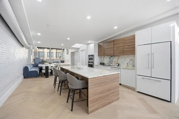 a kitchen with a refrigerator and a table