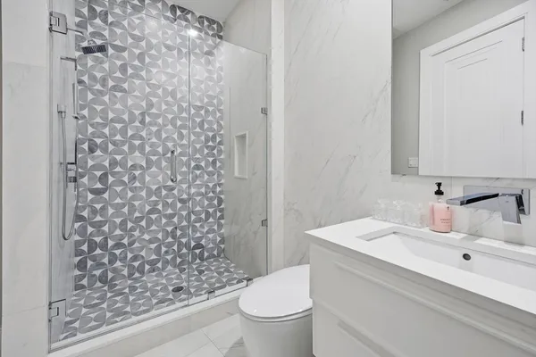 a spacious bedroom with a bed and a flat screen tv