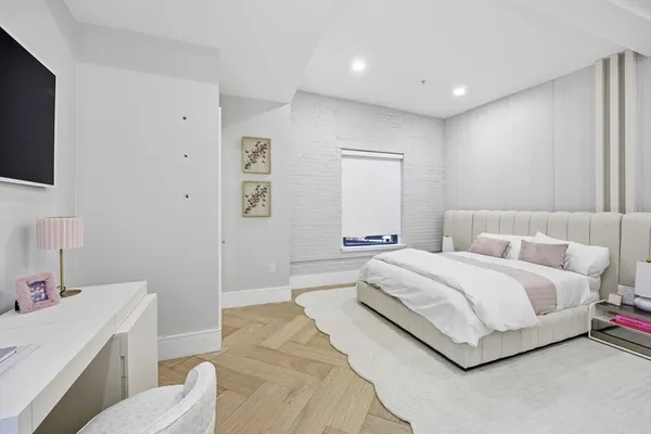 a bedroom with a bed and a night stand