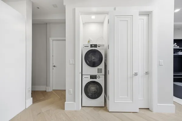 a room with a white bed and furniture