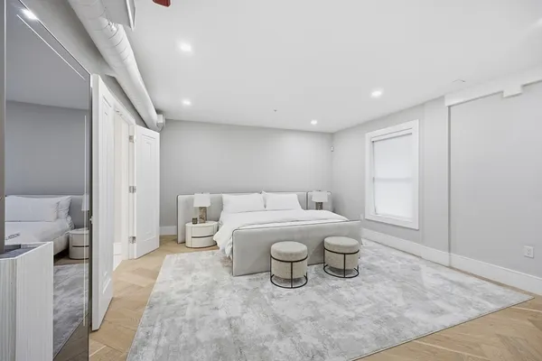 a spacious bathroom with a toilet sink and mirror