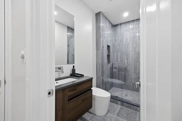 a bathroom with a toilet and a mirror