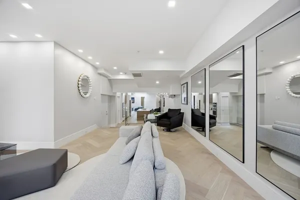 a large bedroom with a large bed and glass door