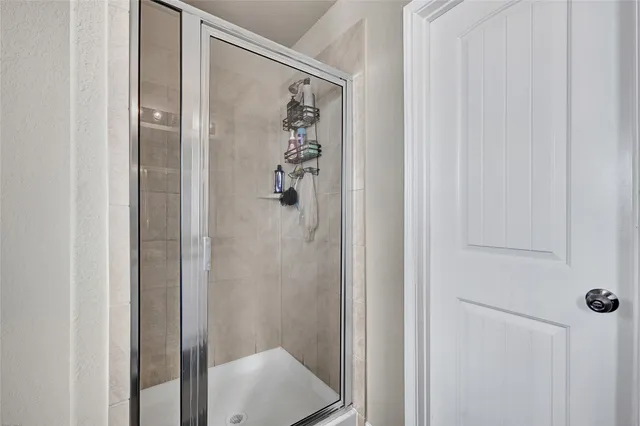 a bathroom with a glass shower door