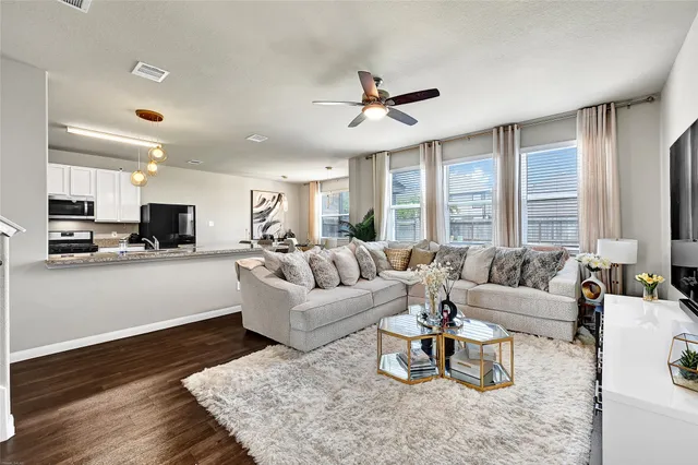 a living room with furniture or kitchen view and a wooden floor