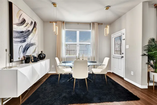 a view of a dining room with furniture and wooden floor