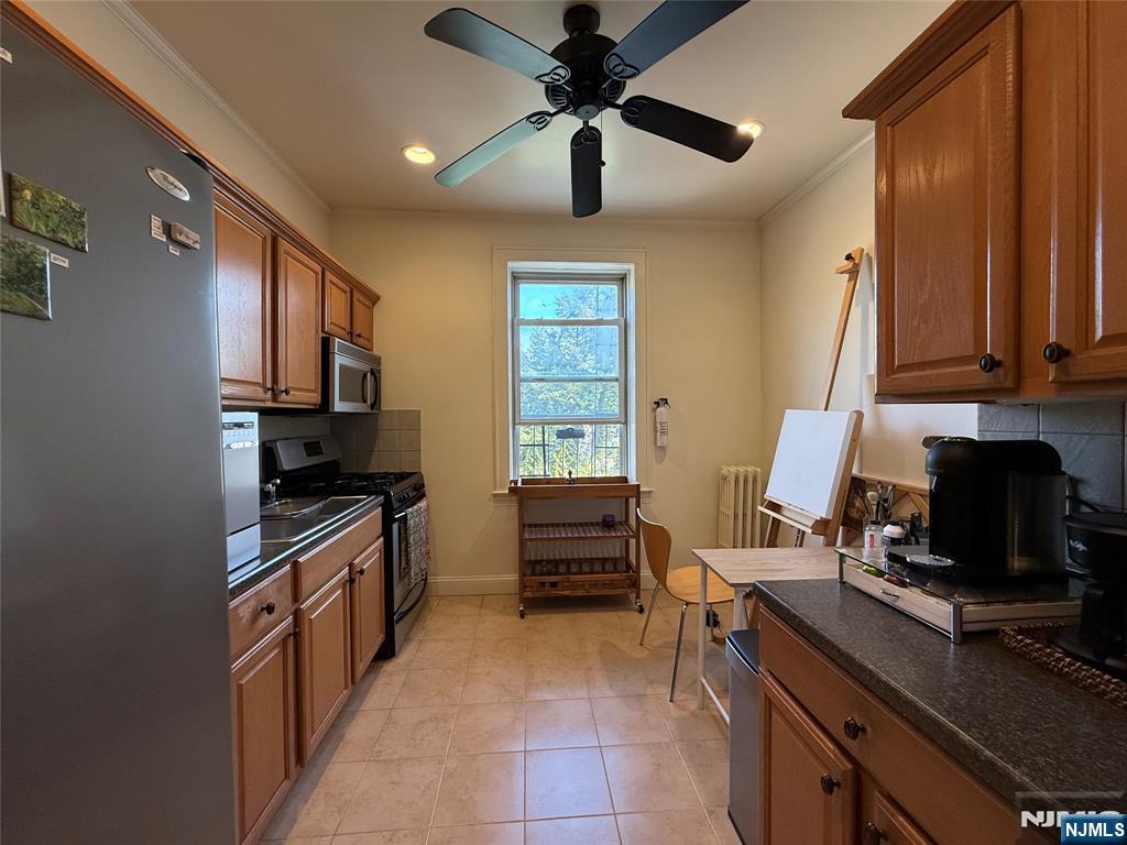 215 Orient Way, Unit C2 Rutherford, NJ 07070 - Photo 9 of 25 a kitchen with stainless steel appliances granite countertop a stove sink and cabinets