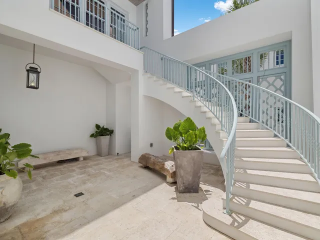 a bathroom with a granite countertop sink a mirror and shower