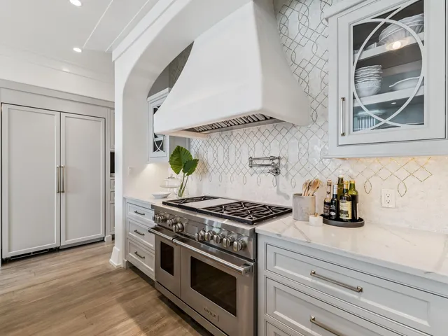 a kitchen with sink and chairs