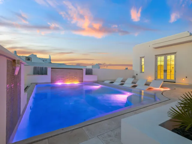 a dining room with furniture and a window