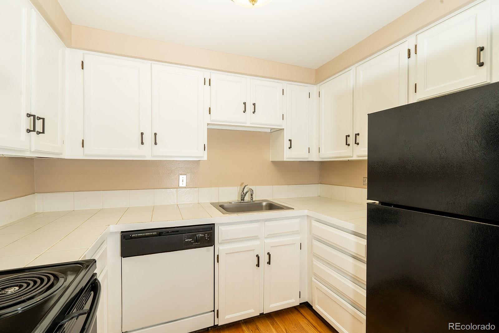 1350 Josephine Street, Unit 101 Denver, CO 80206 - Photo 13 of 13 a kitchen with a sink and a refrigerator