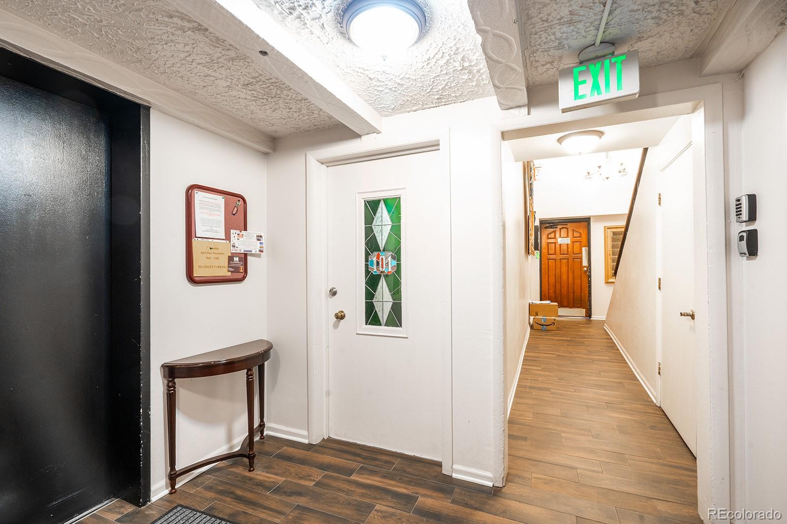 1350 Josephine Street, Unit 101 Denver, CO 80206 - Photo 2 of 13 a view of a hallway with wooden floor and windows
