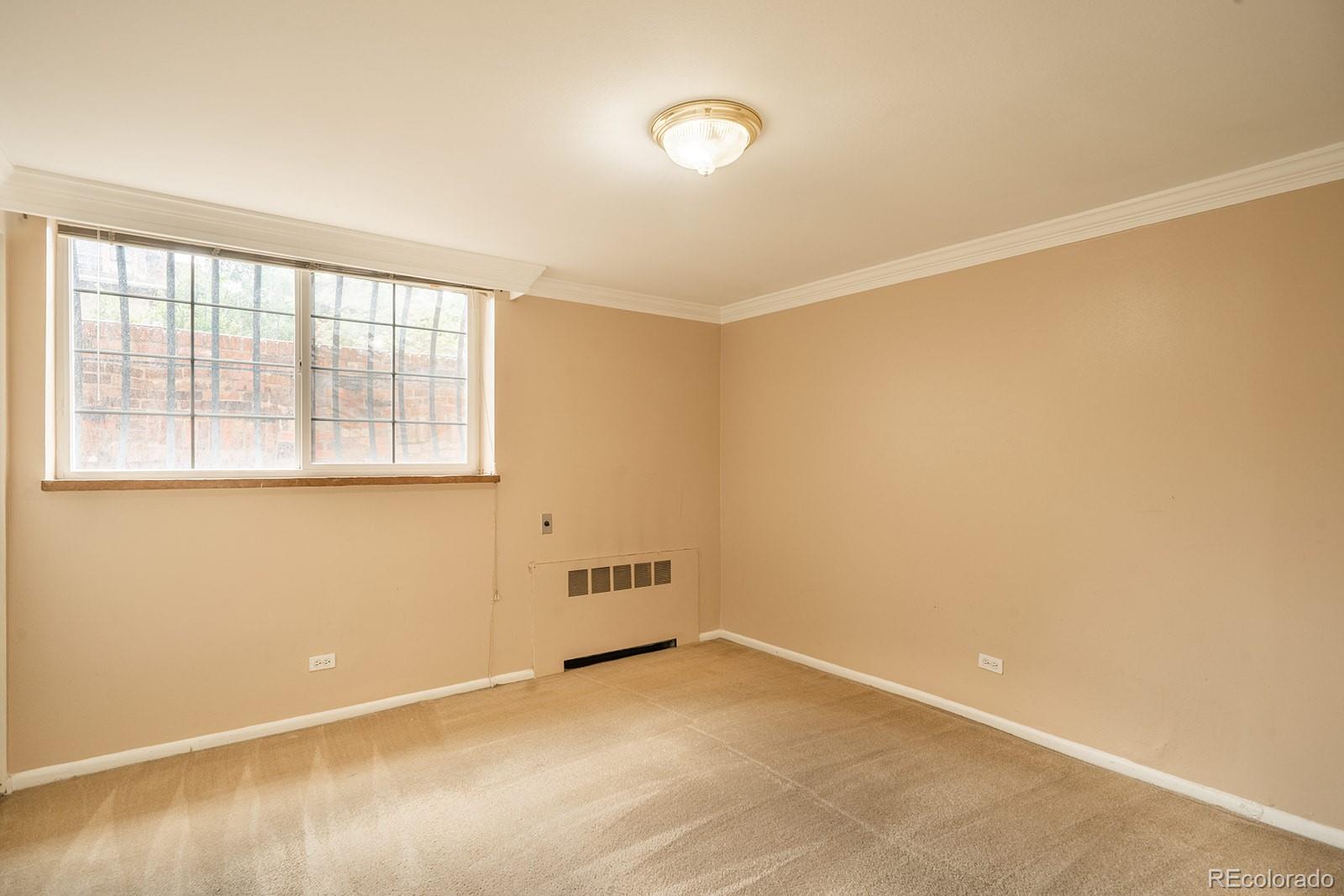 1350 Josephine Street, Unit 101 Denver, CO 80206 - Photo 5 of 13 an empty room with a empty space and a window