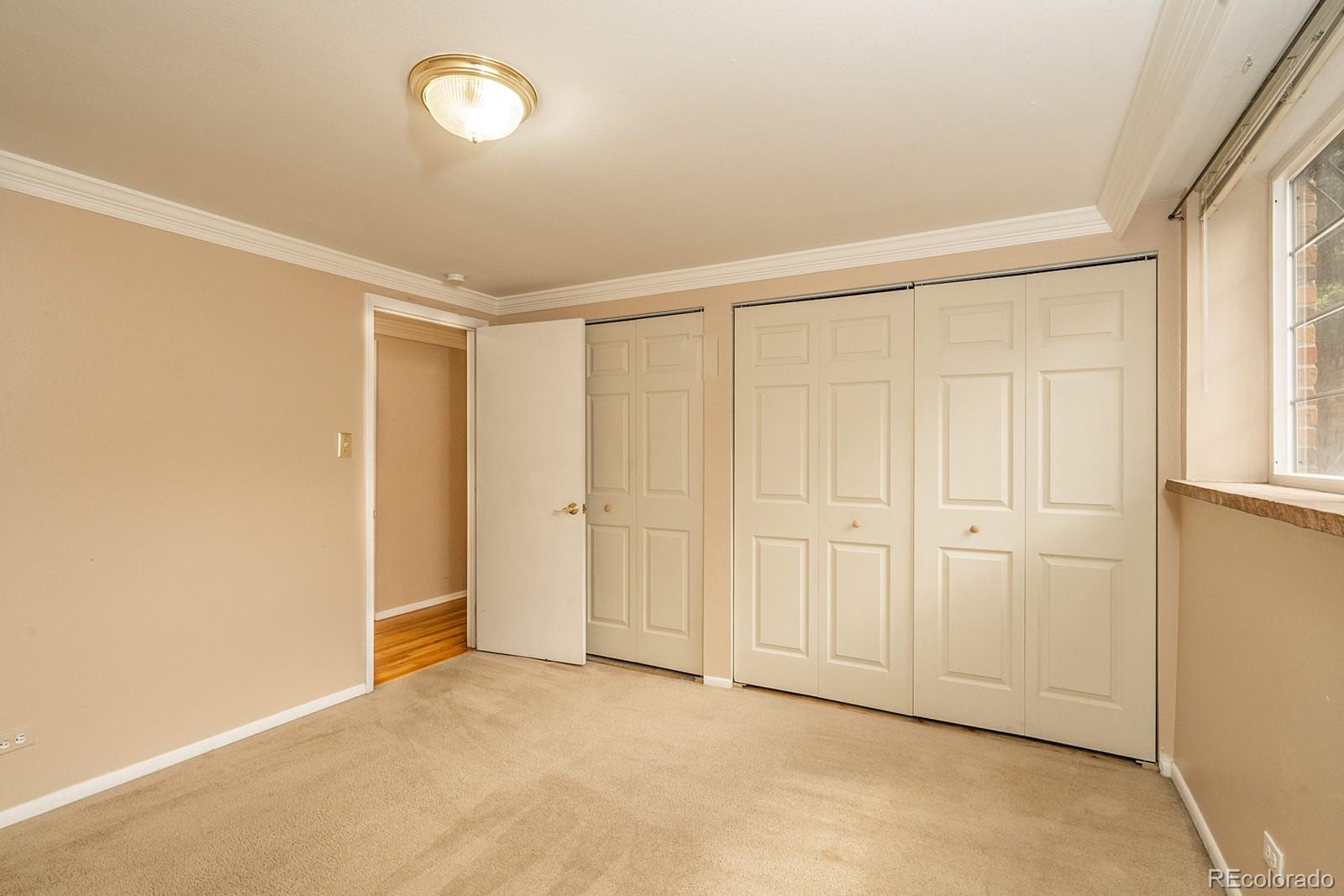1350 Josephine Street, Unit 101 Denver, CO 80206 - Photo 7 of 13 an empty room with windows and closet