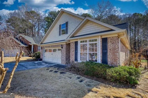 a view of a house with a small yard and floor to ceiling window