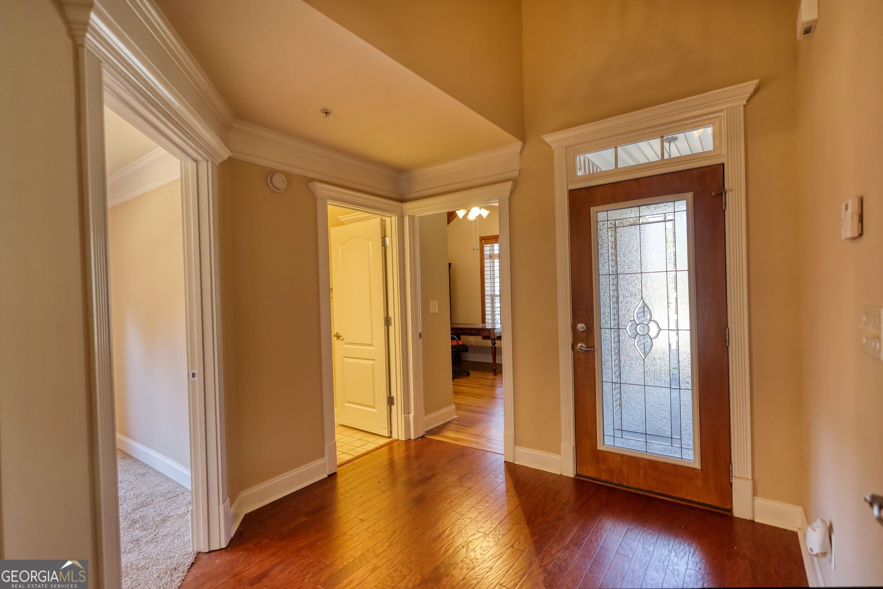 10110 Malcolm Court Covington, GA 30014 - Photo 14 of 60 a view of an empty room with wooden floor and a window