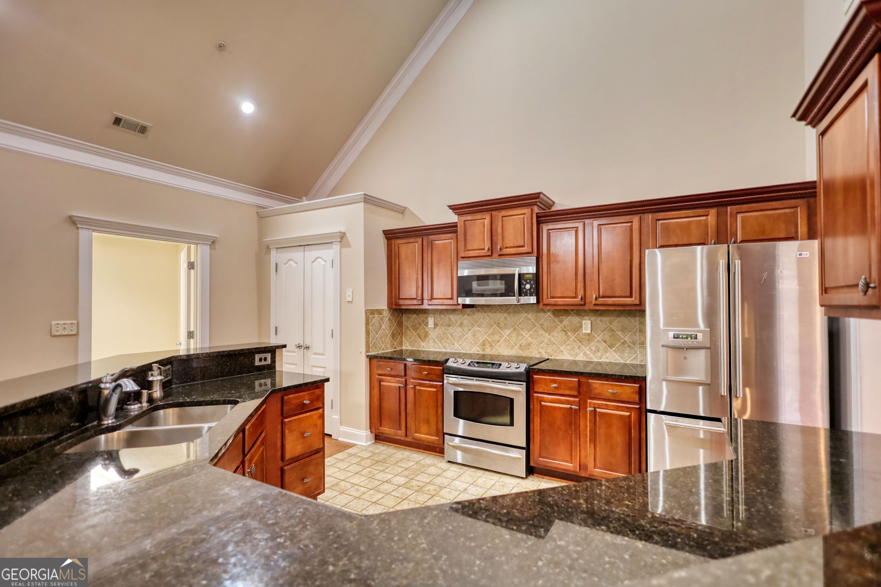 10110 Malcolm Court Covington, GA 30014 - Photo 22 of 60 a kitchen with stainless steel appliances granite countertop a sink stove and refrigerator