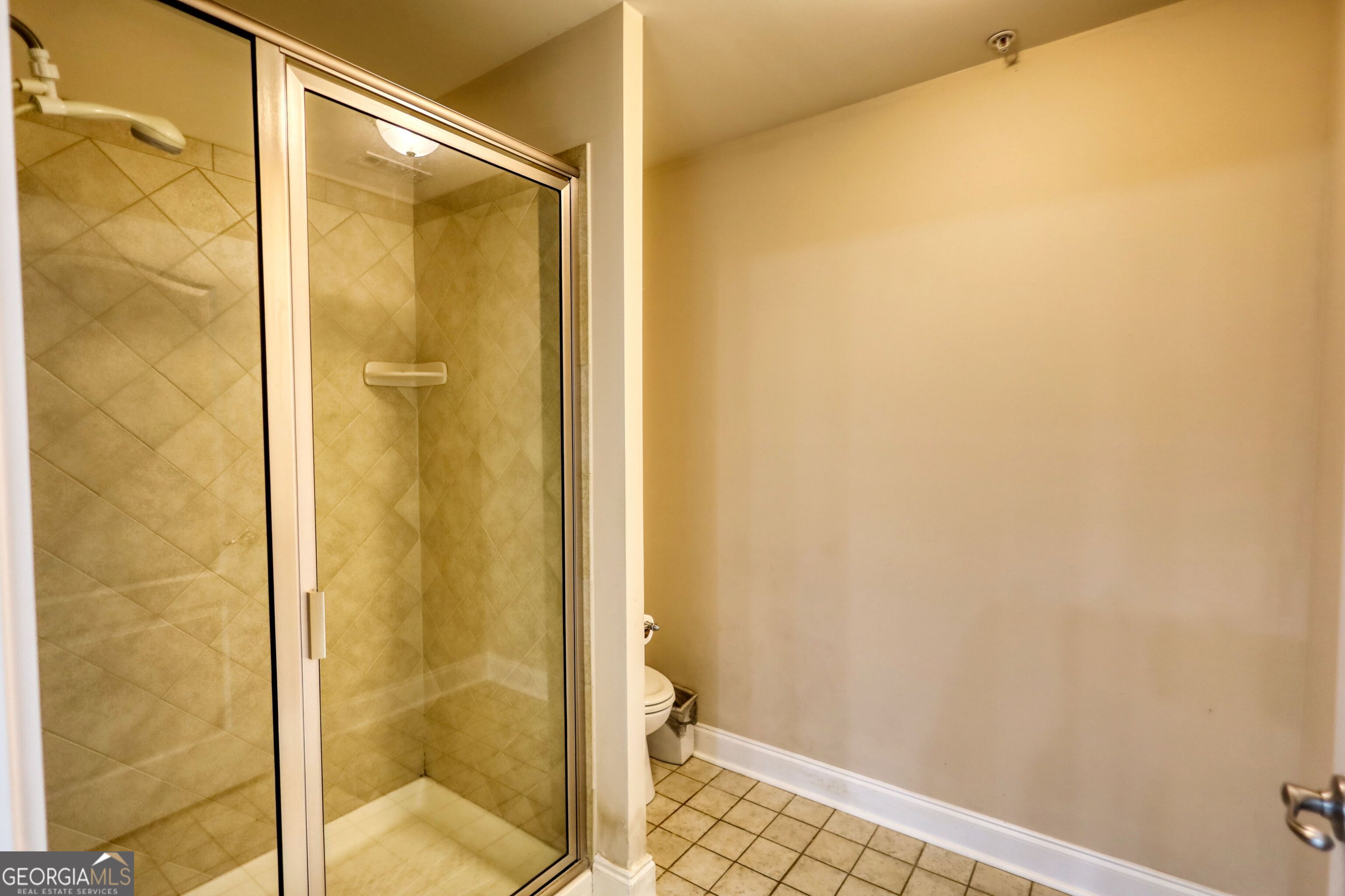 10110 Malcolm Court Covington, GA 30014 - Photo 53 of 60 a bathroom with a glass shower door
