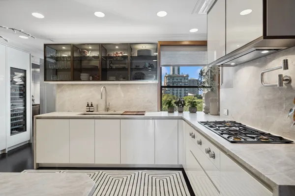 a kitchen with stainless steel appliances granite countertop a stove a sink and a microwave