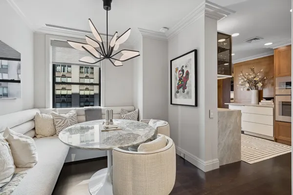 a living room with furniture and a chandelier