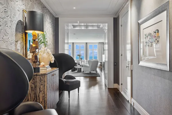 a living room with furniture and a chandelier